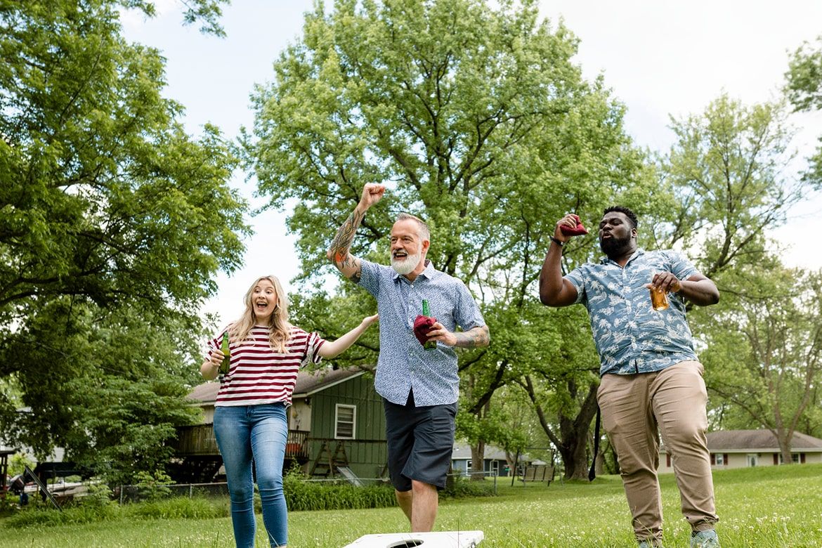 3 people playing game outside